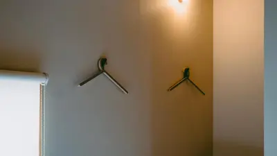 three knives hanging on a wall in a room at Sumida Nagaya in Tokyo