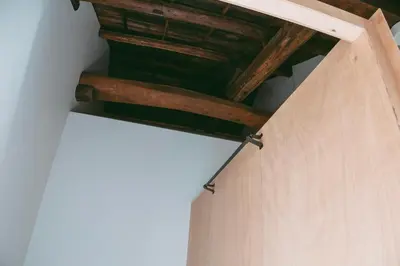 a ceiling with wooden beams in a room at Sumida Nagaya in Tokyo