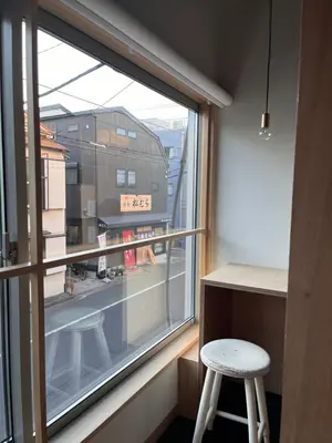 a room with a window and a stool next to a desk at Sumida Nagaya in Tokyo