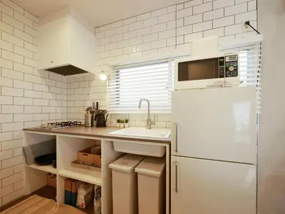 a kitchen with a white refrigerator and a sink at 846 apartment in Tokyo