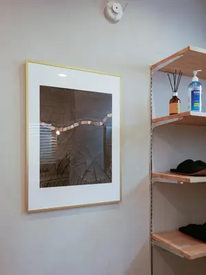 a picture hanging on a wall next to a fireplace at 846 apartment in Tokyo