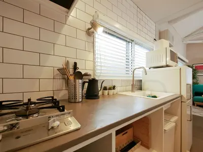 a kitchen with a sink and a stove top oven at 846 apartment in Tokyo