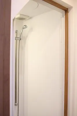a shower in a bathroom with a glass door at Hostel Kura in Tokyo