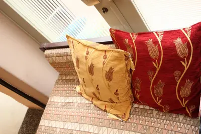 two red and gold pillows sitting on a staircase at Hostel Kura in Tokyo