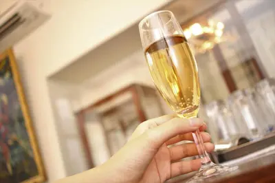 a person is holding a glass of champagne at Hostel Kura in Tokyo