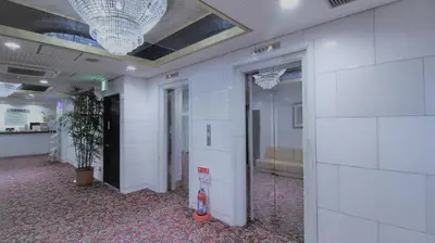 a hallway with white walls and a ceiling at Royal Hotel Shinokubo in Tokyo