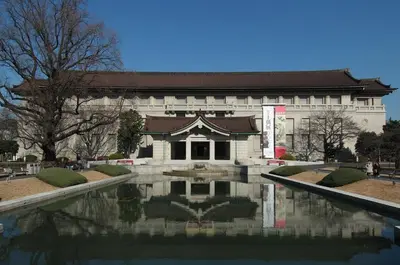 a building with a pond in front of it at Sakura Cross Hotel Ueno Iriya in Tokyo