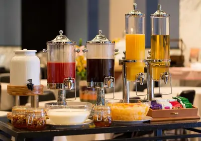 a table with four different colored drinks in glass containers at Hotel Monterey Hanzomon in Tokyo