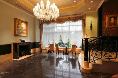 a dining room with a table and chairs and a chandelier at Hotel Monterey Akasaka in Tokyo