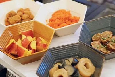 a table with three bowls of different types of food at Hotel Monterey Akasaka in Tokyo