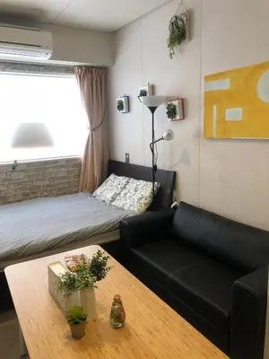 a small room with a bed and a couch and a table at Tokyo Art House in Tokyo