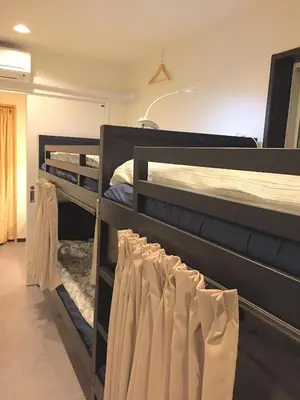 two bunk beds in a room with towels hanging from them at Tokyo Art House in Tokyo