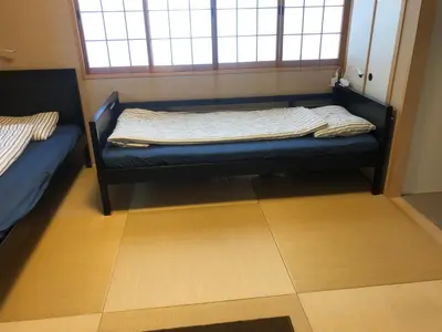 a small room with a bed and a window at Tokyo Art House in Tokyo
