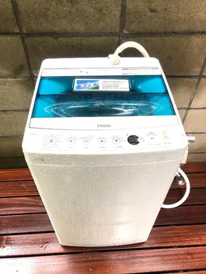 a washing machine sitting on top of a wooden table at Tokyo Art House in Tokyo
