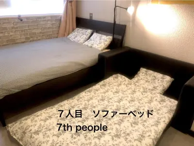 a bedroom with a bed and a rug at Tokyo Art House in Tokyo
