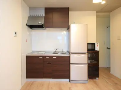 a kitchen with a refrigerator and a sink at COTO Tokyo Shibuya 3 in Tokyo