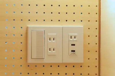 a wall with an electrical device on it at &AND HOSTEL AKIHABARA in Tokyo