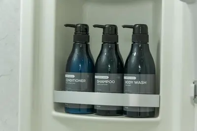 a refrigerator with four bottles of wine in it at &AND HOSTEL AKIHABARA in Tokyo