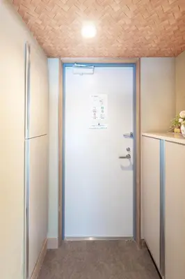 a white door in a room with a counter at Nihonbashi Kakigara Ryokan in Tokyo