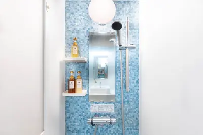 a bathroom with a shower and a sink at Nihonbashi Kakigara Ryokan in Tokyo