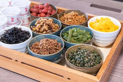 a tray filled with bowls of different types of food at Premier Hotel Cabin Shinjuku in Tokyo