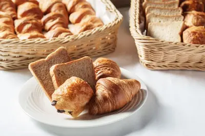 a plate of bread and pastries on a table at Premier Hotel Cabin Shinjuku in Tokyo
