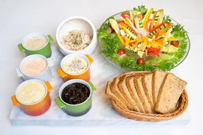 a tray of food with a salad and a plate of food at Premier Hotel Cabin Shinjuku in Tokyo