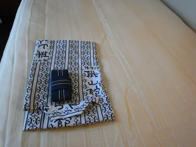 a bed with a black and white pattern on it at Hotel Kizankan in Tokyo