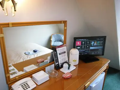 a desk with a computer on it in a room at Hotel Kizankan in Tokyo