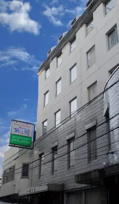 a tall building with a sign in front of it at Hotel Kizankan in Tokyo