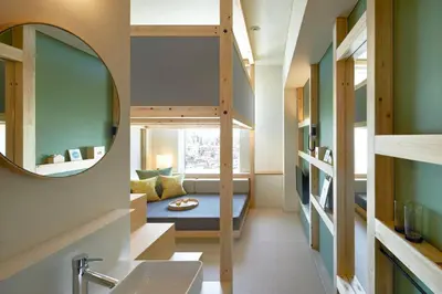 a small room with a bunk bed and a mirror at OMO5 Tokyo Otsuka by Hoshino Resorts in Tokyo