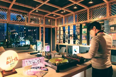 a woman standing at a counter in a sushi shop at OMO5 Tokyo Otsuka by Hoshino Resorts in Tokyo