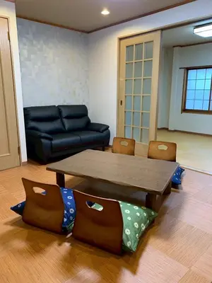 a living room with a table and a couch at HOTEL PRELE Asakusa \u30db\u30c6\u30eb\u30d7\u30ec\u30fc\u30eb\u6d45\u8349 in Tokyo