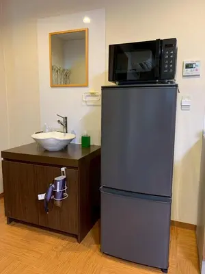 a microwave on top of a refrigerator next to a sink at HOTEL PRELE Asakusa \u30db\u30c6\u30eb\u30d7\u30ec\u30fc\u30eb\u6d45\u8349 in Tokyo
