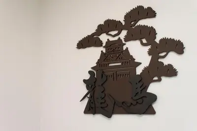a wooden cut out of a tree with a building at Ryoma Ikebukuro in Tokyo