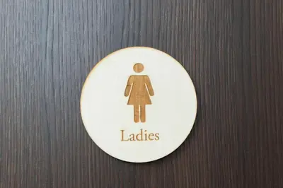 a sign that says ladies on a wooden door at Ryoma Ikebukuro in Tokyo
