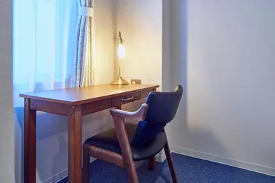 a desk with a chair and a lamp on it at Turn Table in Tokyo