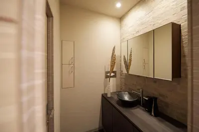 a bathroom with a sink and a mirror at Turn Table in Tokyo