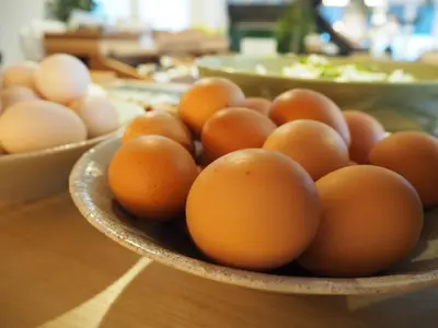 a bowl of eggs on a wooden table at Turn Table in Tokyo