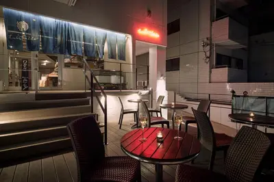 a restaurant with tables and chairs and a bar at Turn Table in Tokyo