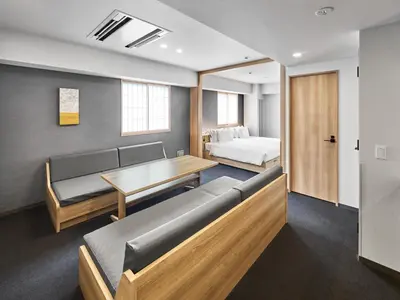 a room with a couch and a table and a bed at MIMARU Tokyo Akasaka in Tokyo