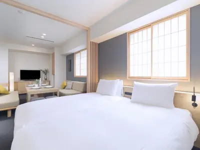 a bedroom with a large white bed and a living room at MIMARU Tokyo Akasaka in Tokyo