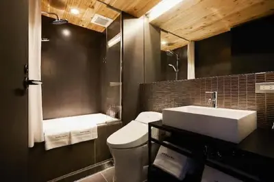 a bathroom with a white sink and a toilet at Arcsens Tokyo in Tokyo