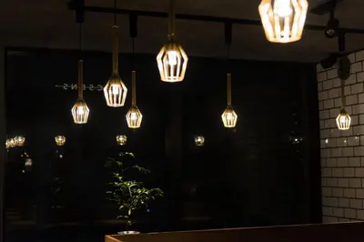 a dark room with lights hanging from the ceiling at Arcsens Tokyo in Tokyo