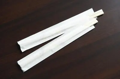 two pieces of white paper on a wooden table at Sotetsu Fresa Inn Tokyo Kanda in Tokyo