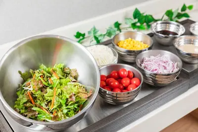 a buffet with bowls of food on a counter at Sotetsu Fresa Inn Tokyo Kanda in Tokyo