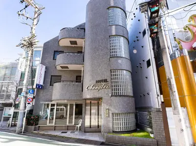 a building with a sign on the side of it at Chang Tee Hotel Ikebukuro in Tokyo