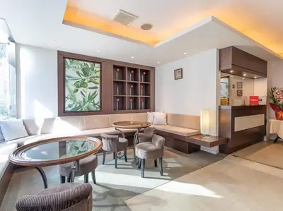 a living room with a couch and a table and chairs at Chang Tee Hotel Ikebukuro in Tokyo