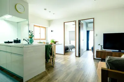 a kitchen with a sink and a living room at Home n Lounge in Tokyo