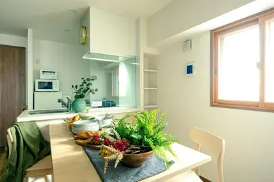 a kitchen with a table with fruits and vegetables on it at Home n Lounge in Tokyo